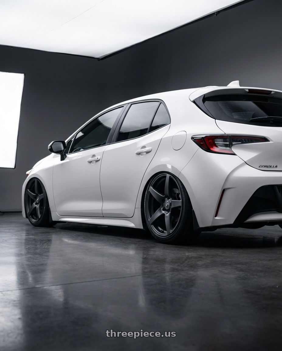 2023 Toyota Corolla Hatchback with Forgestar CF5 5x114.3 18x9 +35 Satin Black wheels rear three quarter view slight stretch tires