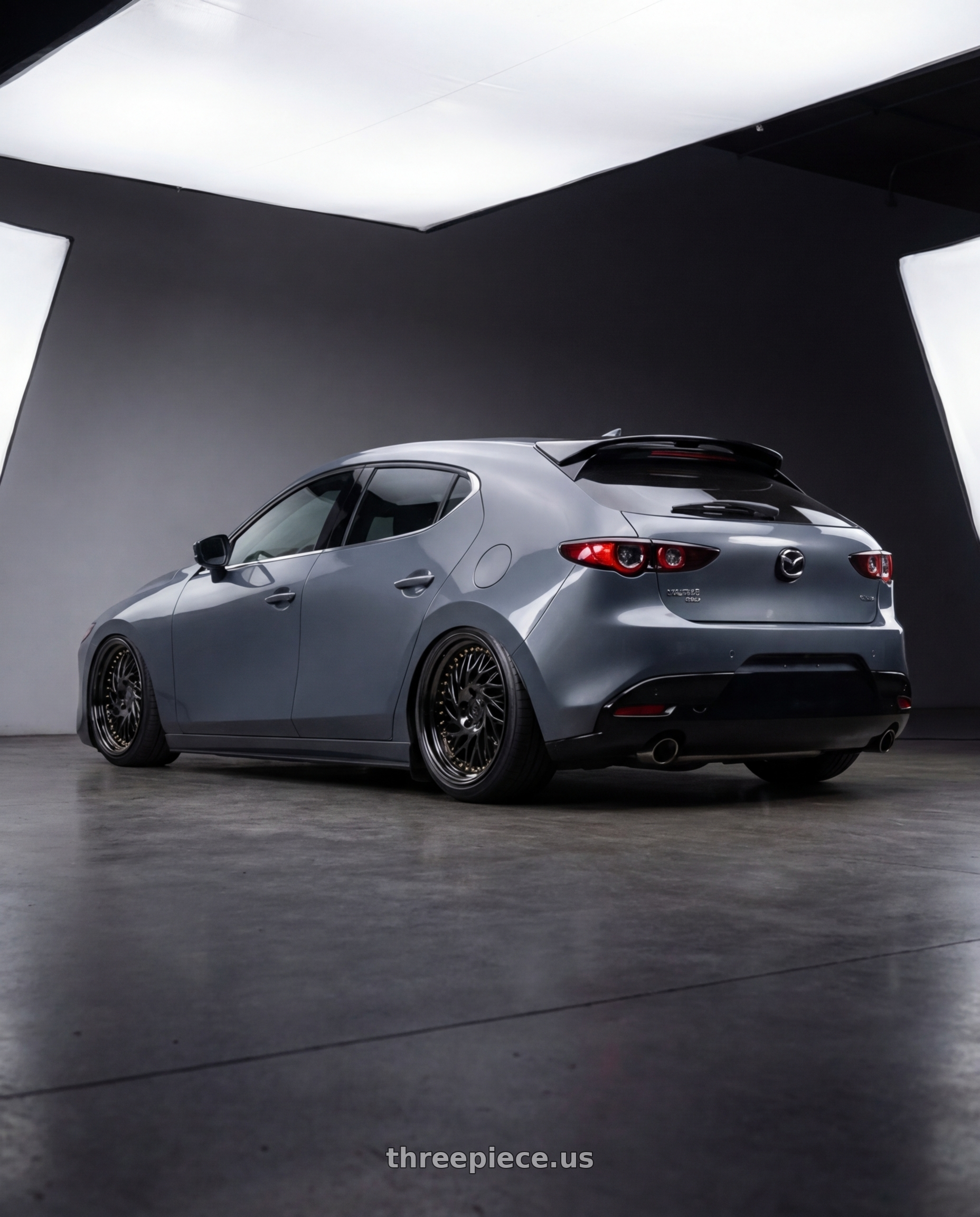 2023 Mazda Mazda3 Turbo with Aodhan DS03 5x114.3 18x9.5 +30 Black Vacuum w/ Gold Rivets wheels rear three quarter view slight stretch tires