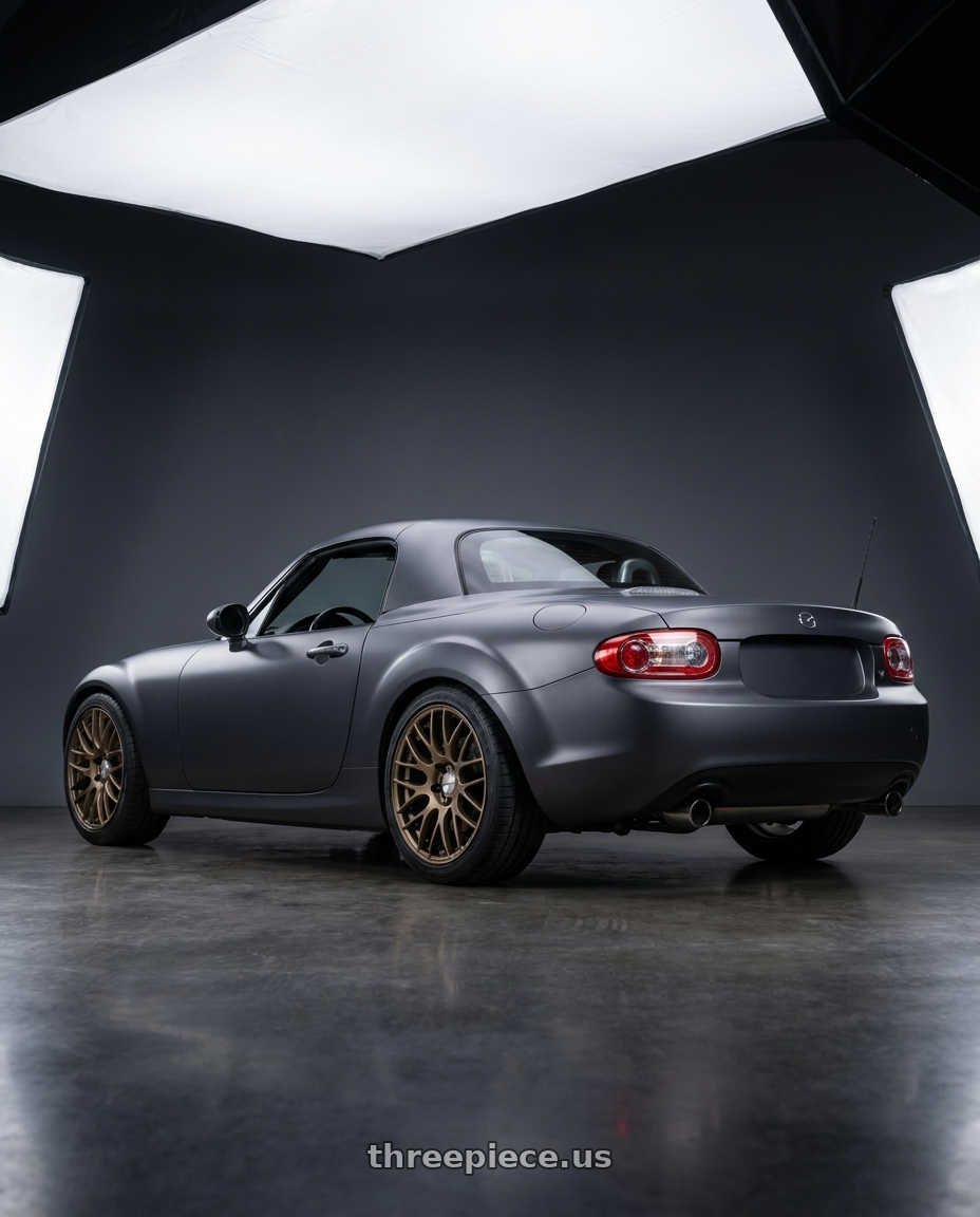 2007 Mazda Miata MX-5 with Work Emotion m8r 5x114.3 17x7 +47 Matte Bronze wheels rear three quarter view square tires