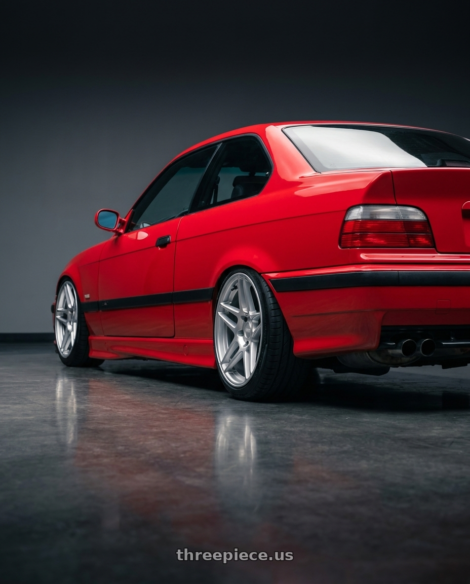 1996 BMW E36 328is with Kansei K15H Astro 5X100 18x9 22 Hyper Silver wheels rear three quarter view slight stretch tires