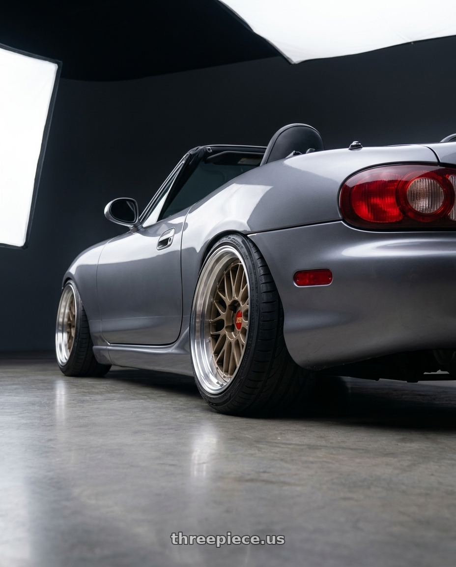 2000 Mazda Miata with BBS LM 5x120 19x11.0+37 Matte Bronze wheels rear three quarter view extreme stretch tires