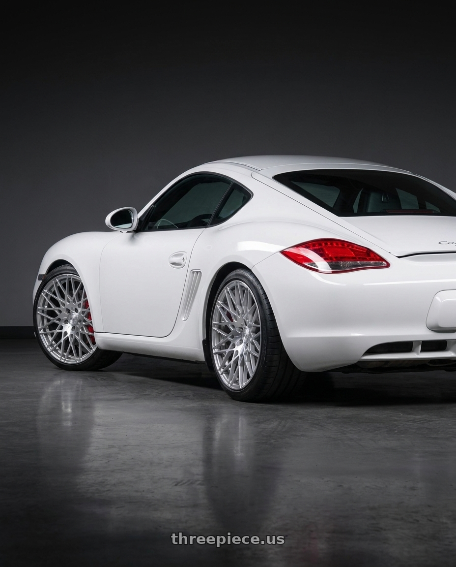 2010 Porsche Cayman 987 2 with Avant Garde M540 5x112 19x8.5 +35 Silver Machine wheels rear three quarter view slight stretch tires