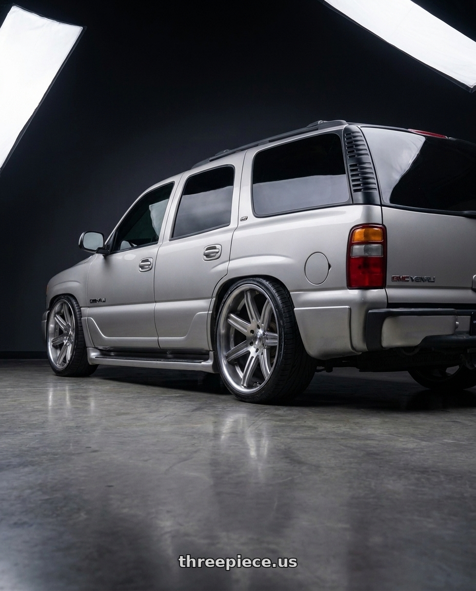 2005 GMC Yukon with Status ST005 MATRIX 6X135/6X139.7 24X10 +30 ANTH-MIR wheels rear three quarter view extreme stretch tires