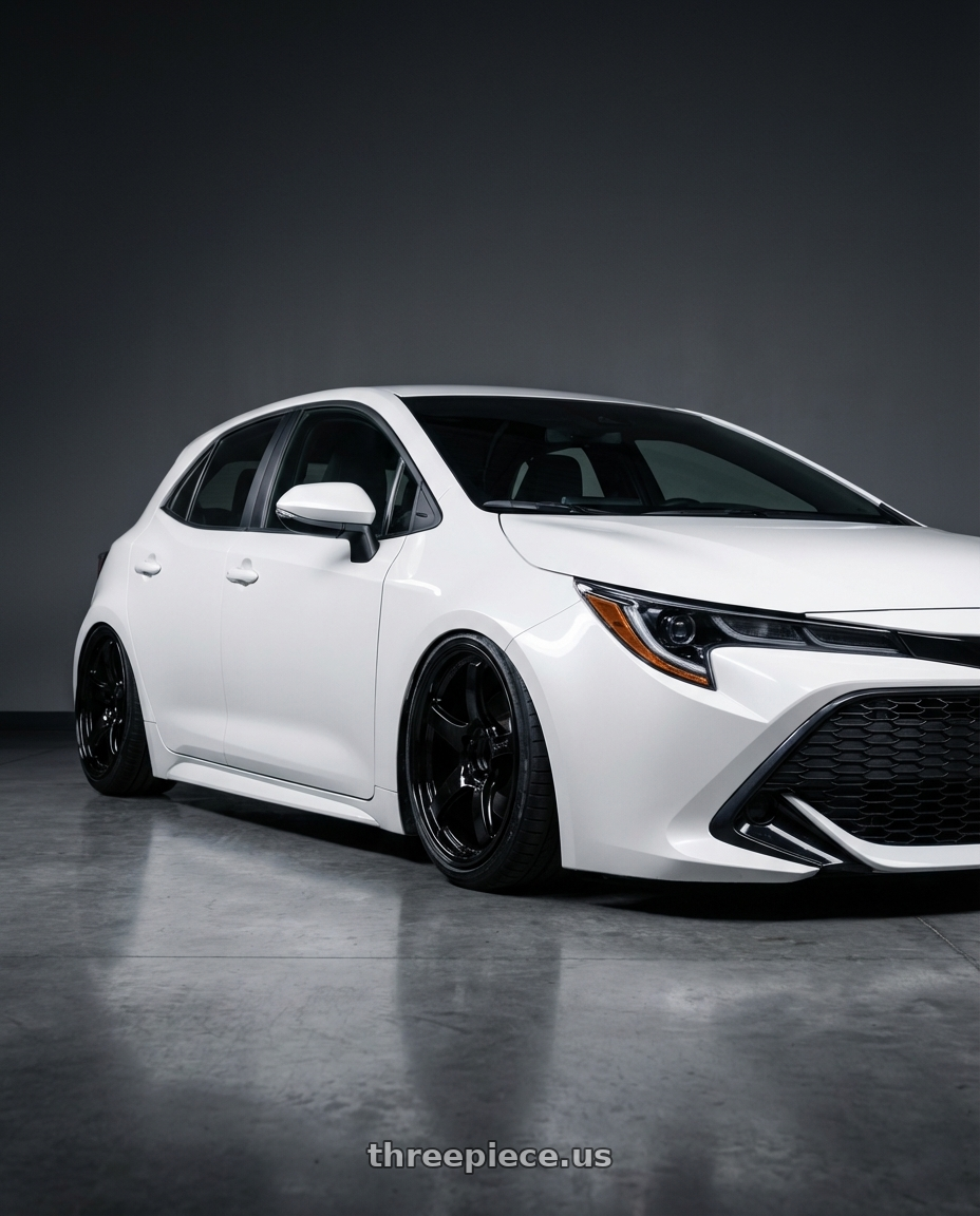 2023 Toyota Corolla Hatchback with Gram Lights 57CR 5x114.3 18x9.5+22 Glossy Black wheels front three quarter view stanced stance