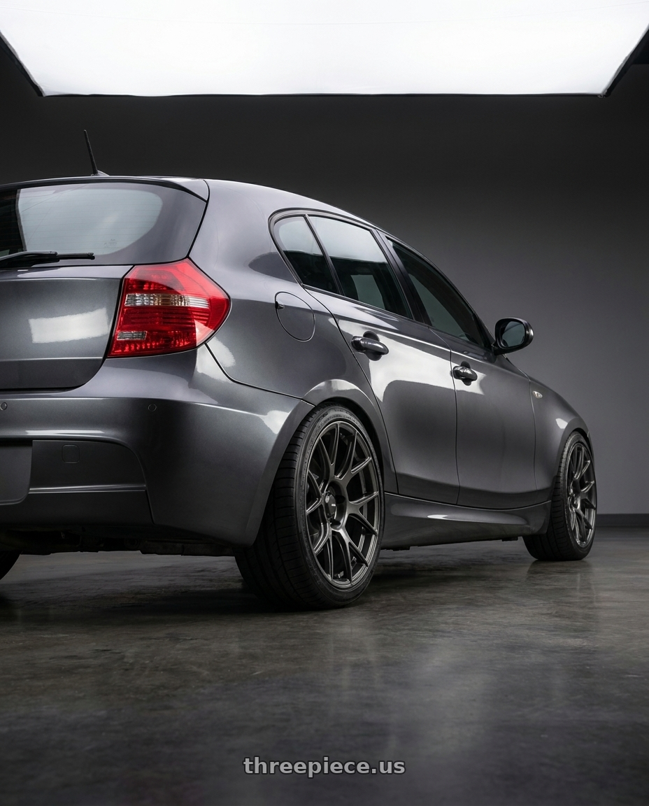 2012 BMW 1 Series E82 with Konig Ampliform 5x120 18x9.5+35 Dark Metallic Graphite wheels rear three quarter view square tires