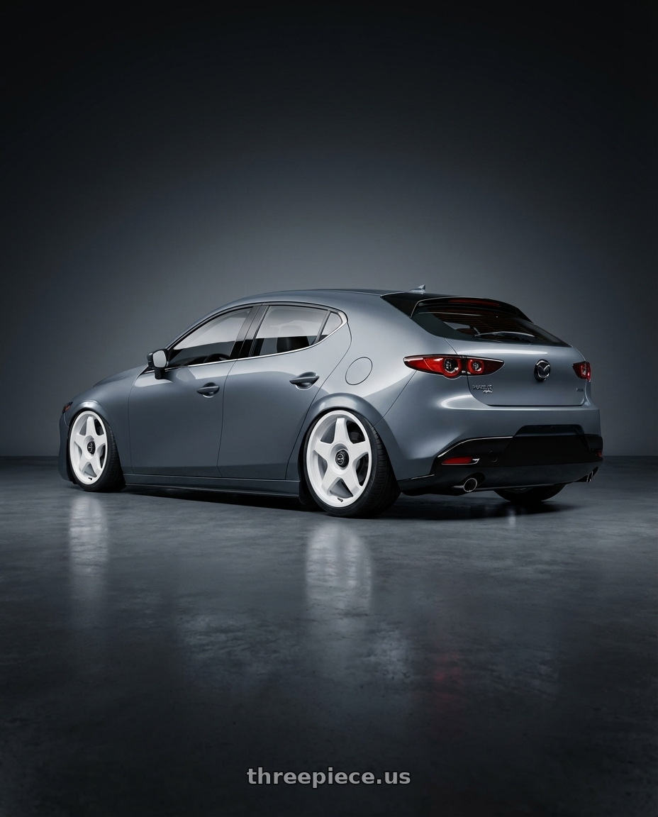 2023 Mazda Mazda3 Turbo with fifteen52 CHICANE 5x114.3 / 5x100 18x8.5 +35 RALLY WHITE (GLOSS WHITE) wheels rear three quarter view slight stretch tires