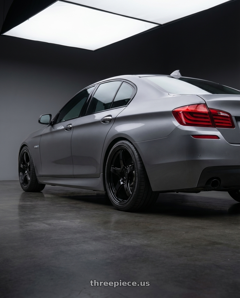 2016 BMW 5 Series F10 with Gram Lights 57CR 5x120 19x10.5+35 Glossy Black wheels rear three quarter view square tires