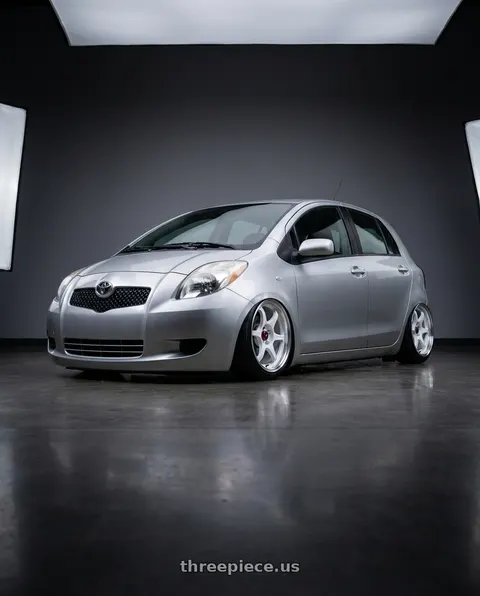2006 Toyota Yaris with Enkei PF06 4x100 15x8+25 White Machined wheels