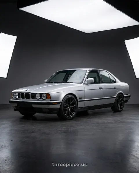 1995 BMW 525i with Bravado 08B Tribute 5X115 18x9 +15 Matte Black wheels