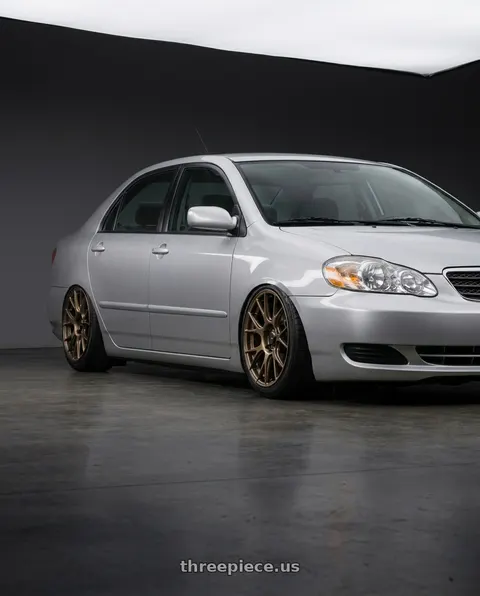 2006 Toyota Corolla with Konig Ampliform 4x100 17x8+45 Gloss Bronze wheels