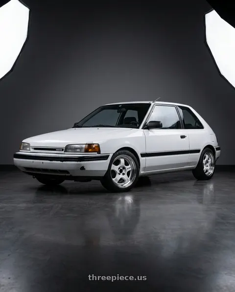 1992 Mazda 323 with Work Meister S1 2P 4x100 15x7+38 R Disk White wheels