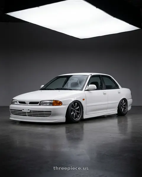 1993 Mitsubishi lancer cab with Enkei Compe 4x114.3 16x8+0 Matte Gunmetal wheels