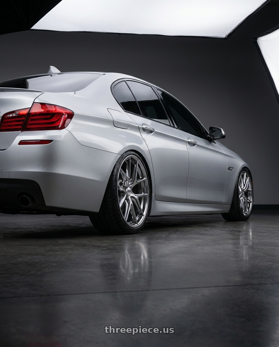 2012 BMW 550i with BBS CI-R 5x120 20x11.5 +52 Ceramic Polished Rim Protector wheels rear three quarter view extreme stretch tires