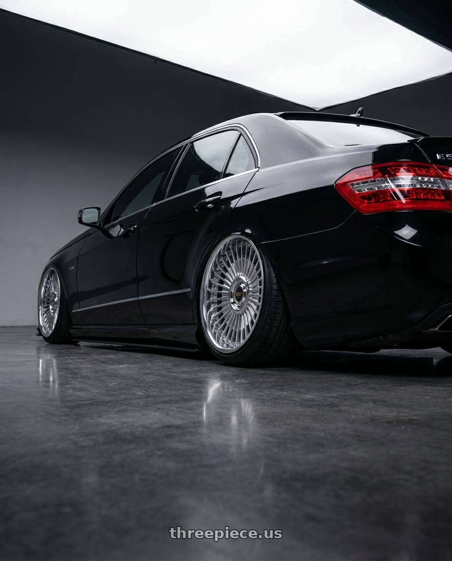2010 Benz E550 with Work Emitz Black Polish 5x100 19x12.0 +22 wheels rear three quarter view slight stretch tires