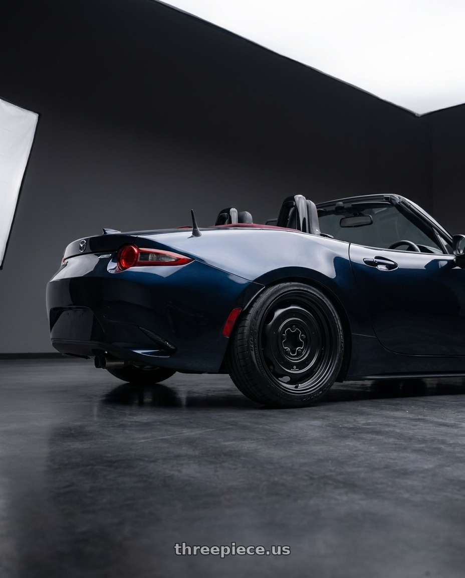 2021 Mazda Mx5 with Mobelwagen MW512B Interceptor 5X112 16x7.5 23 Black wheels rear three quarter view slight stretch tires