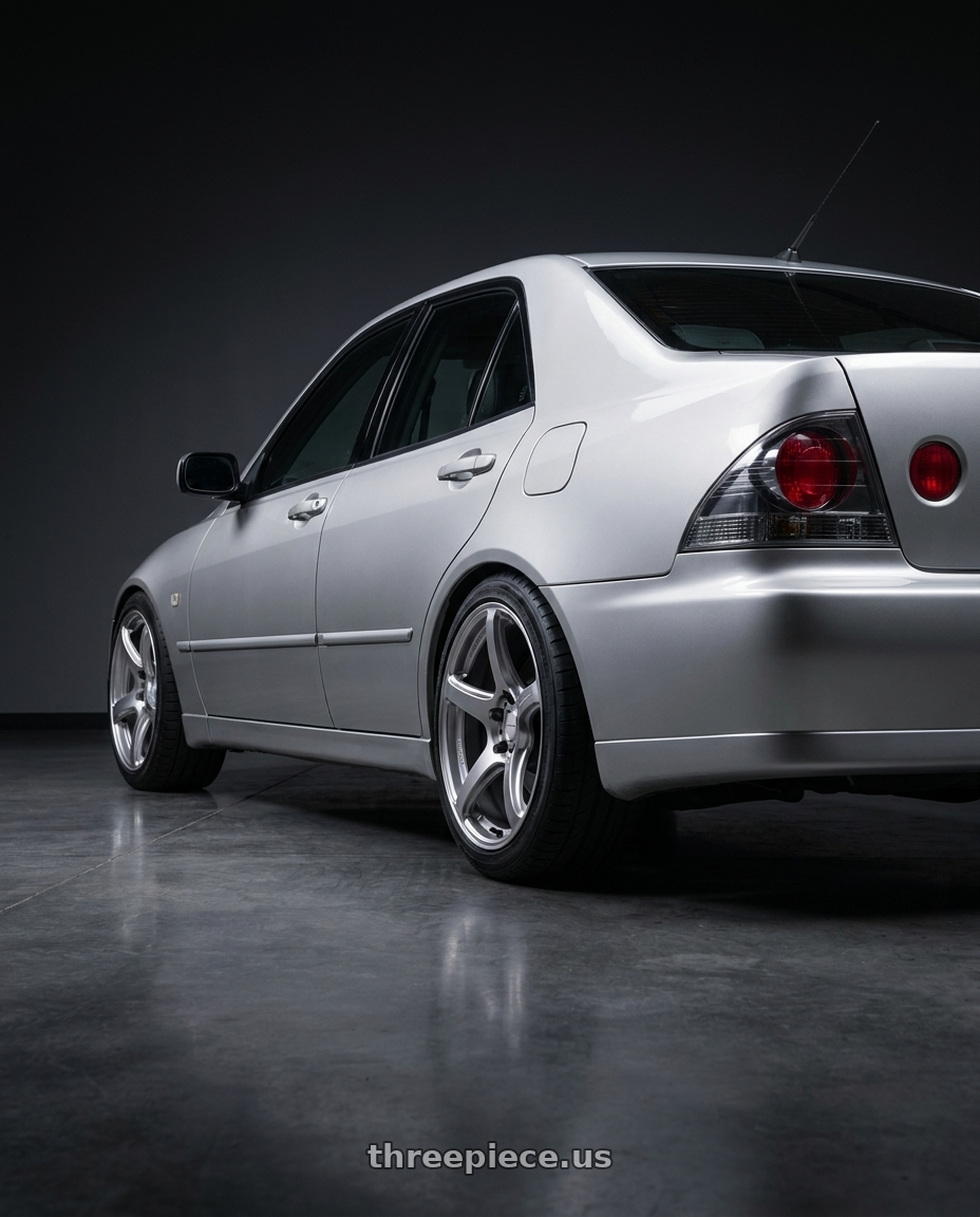 2005 Lexus IS200 limited edition with Work Emotion T5r 5x114.3 17x8 +35 Glow Silver wheels rear three quarter view square tires