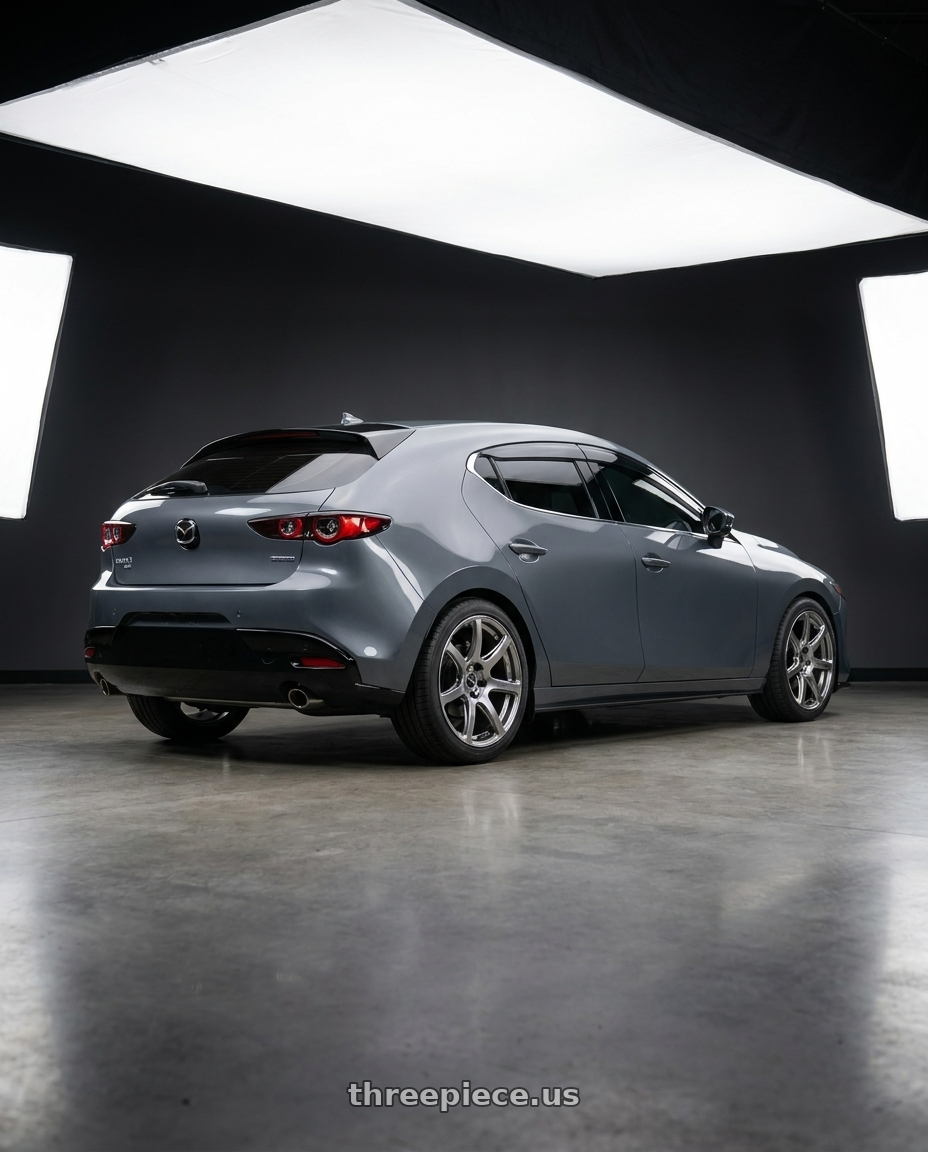 2024 Mazda 3 hatchback turbo premium plus machine grey  with Work Emotion T7r 5x114.3 18x8.5 +38 Gt Silver wheels rear three quarter view square tires