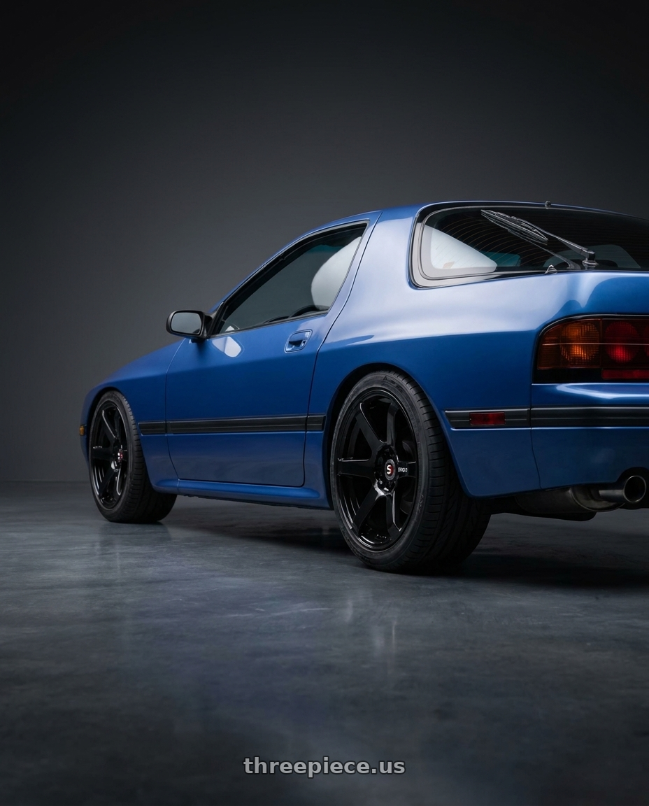 1991 Mazda RX-7 with Spec-1 SPT-32 5x114.3/5x120 17x8 +42 Gloss Black wheels rear three quarter view square tires