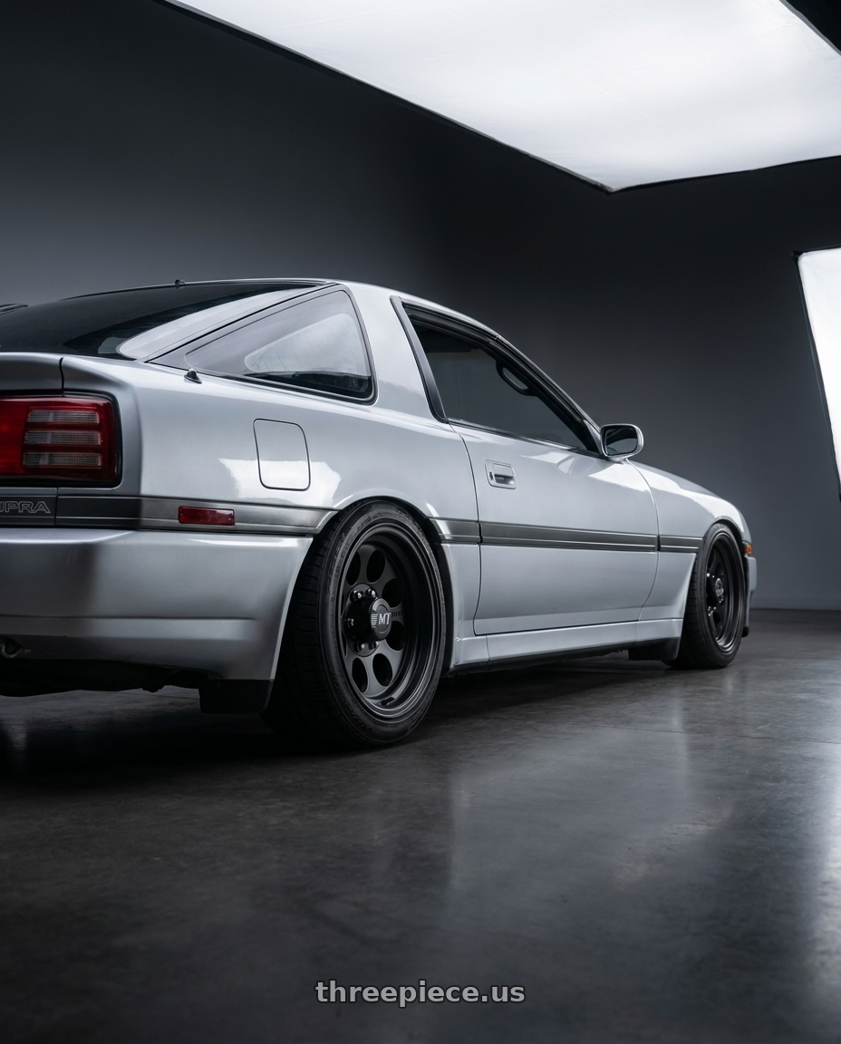 1987 Toyota Supra  with Mickey Thompson Classic III Black 5x139.7 15x8 -22 Matte Black wheels rear three quarter view slight stretch tires
