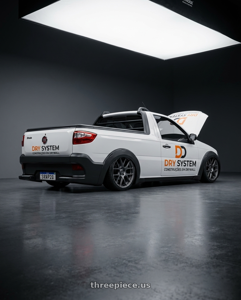 Fiat Strada Hard Working 1.4 CS 2017 - adesivada. Logo no capô with TSW NURBURGRING 5X114.3 17X7.5 +45 MATTE GUNMETAL wheels rear three quarter view square tires