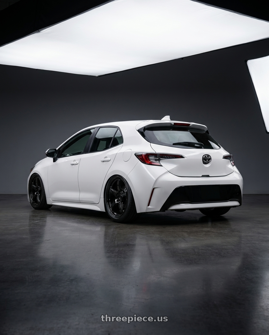 2023 Toyota Corolla Hatchback with Gram Lights 57CR 5x114.3 18x9.5+22 Glossy Black wheels rear three quarter view slight stretch tires