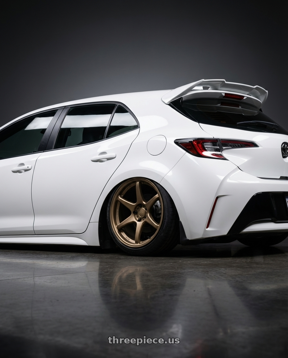 2023 Toyota Corolla Hatchback with Kansei K11B Tandem 5x114.3 18x9 35 Bronze wheels rear three quarter view slight stretch tires