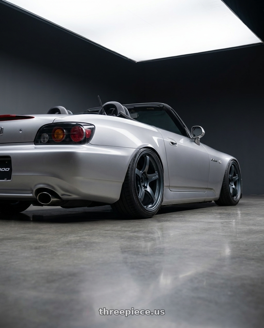 2009 Honda S2000 with Gram Lights 57CR 5x114.3 18x9.5+12 Gunblue II wheels rear three quarter view slight stretch tires