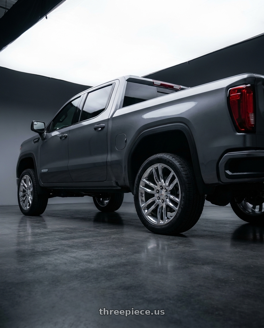 2023 GMC sierra 1500 elevation in titanium rush metallic with OE Wheels CV43B 6x139.7 22x9+24 Chrome wheels rear three quarter view square tires