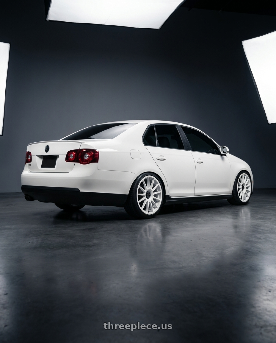 2008 Volkswagen Jetta GLI in White with fifteen52 PODIUM 5x108 / 5x112 18x8.5 +45 RALLY WHITE (GLOSS WHITE) wheels rear three quarter view square tires