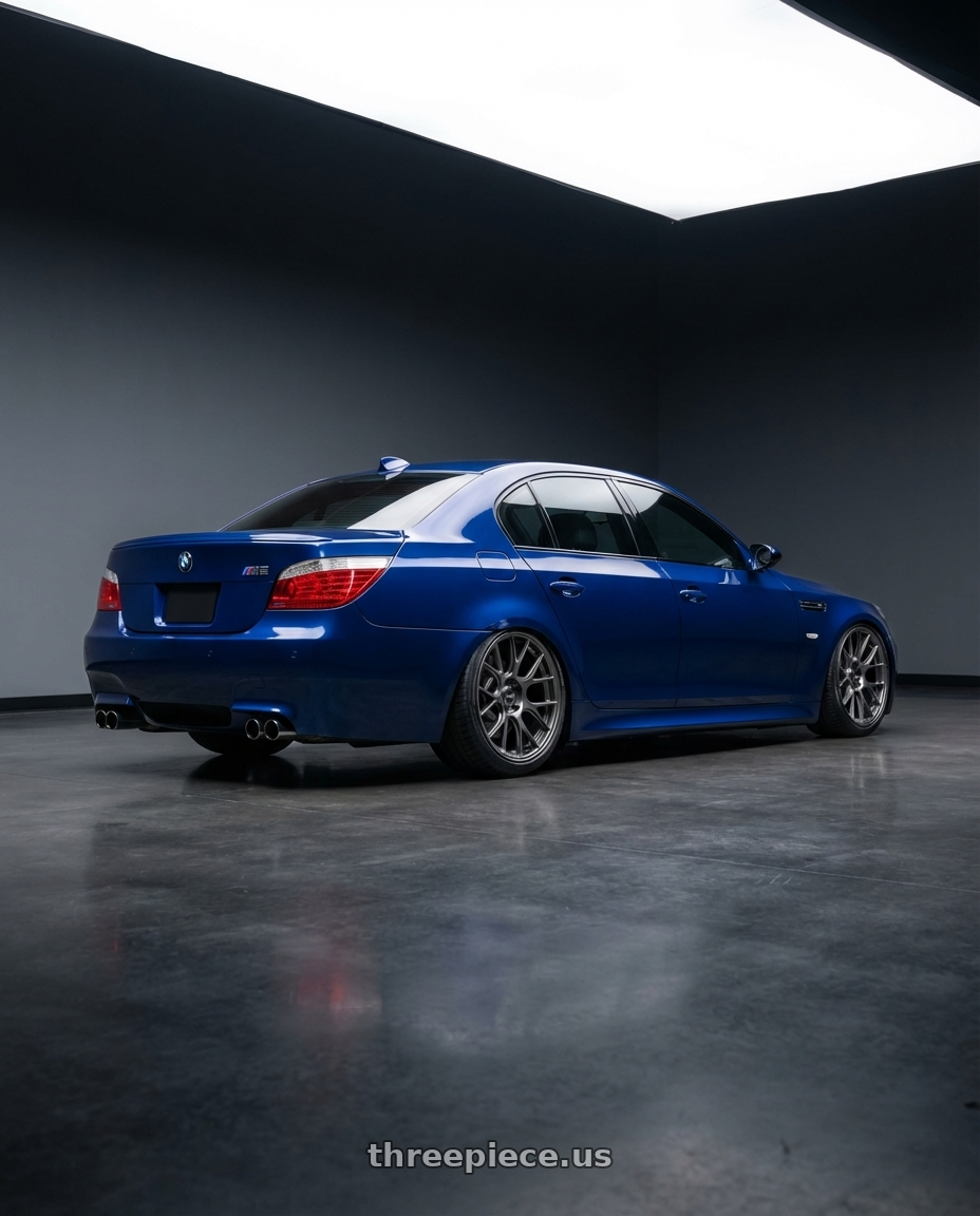 2010 BMW M5 E60 with Konig Ampliform 5x120 20x8.5+45 Dark Metallic Graphite wheels rear three quarter view slight stretch tires