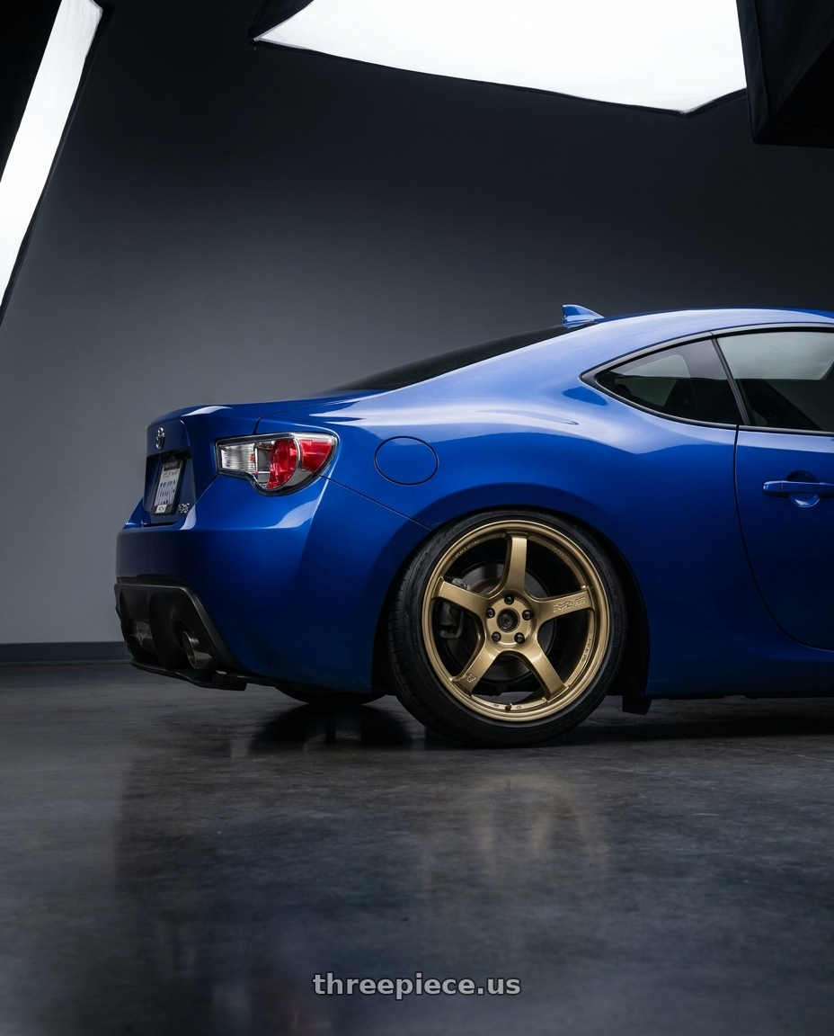 2013 Scion FR-S in Ultramarine Blue with Gram Lights 57CR 5x114.3 18x9.5 +38 Almite Gold wheels rear three quarter view square tires