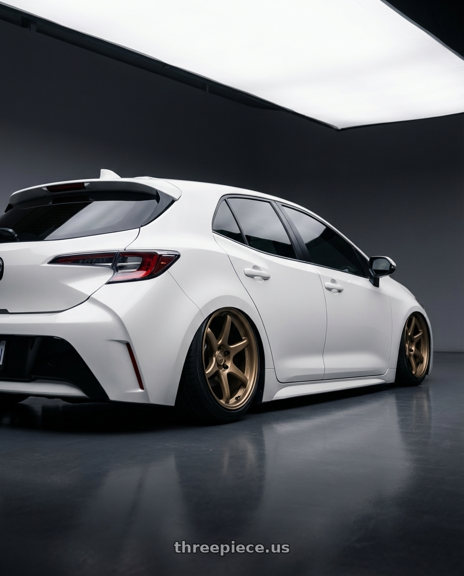 2023 Toyota Corolla Hatchback with Kansei K11B Tandem 5x114.3 18x9 12 Bronze wheels rear three quarter view slight stretch tires
