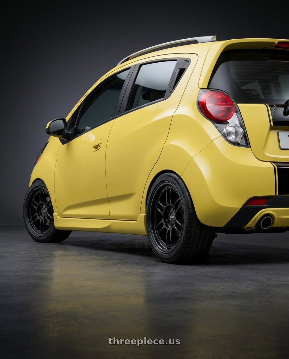 2015 Chevy Spark LS Lemonade with Enkei RPF1 4x100 15x8+28 Black wheels rear three quarter view square tires