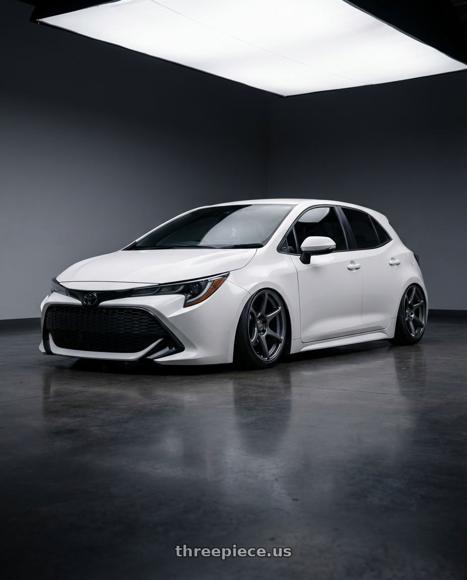 2023 Toyota Corolla Hatchback with Kansei K11G Tandem 5x114.3 18x9 35 Gunmetal wheels front three quarter view stanced stance
