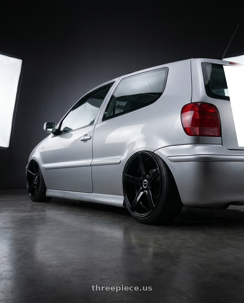 2000 Volkswagen Polo 1 4 with Strada Perfetto 5x110/5x114.3 16x7.5 +35 Gloss Black wheels rear three quarter view extreme stretch tires