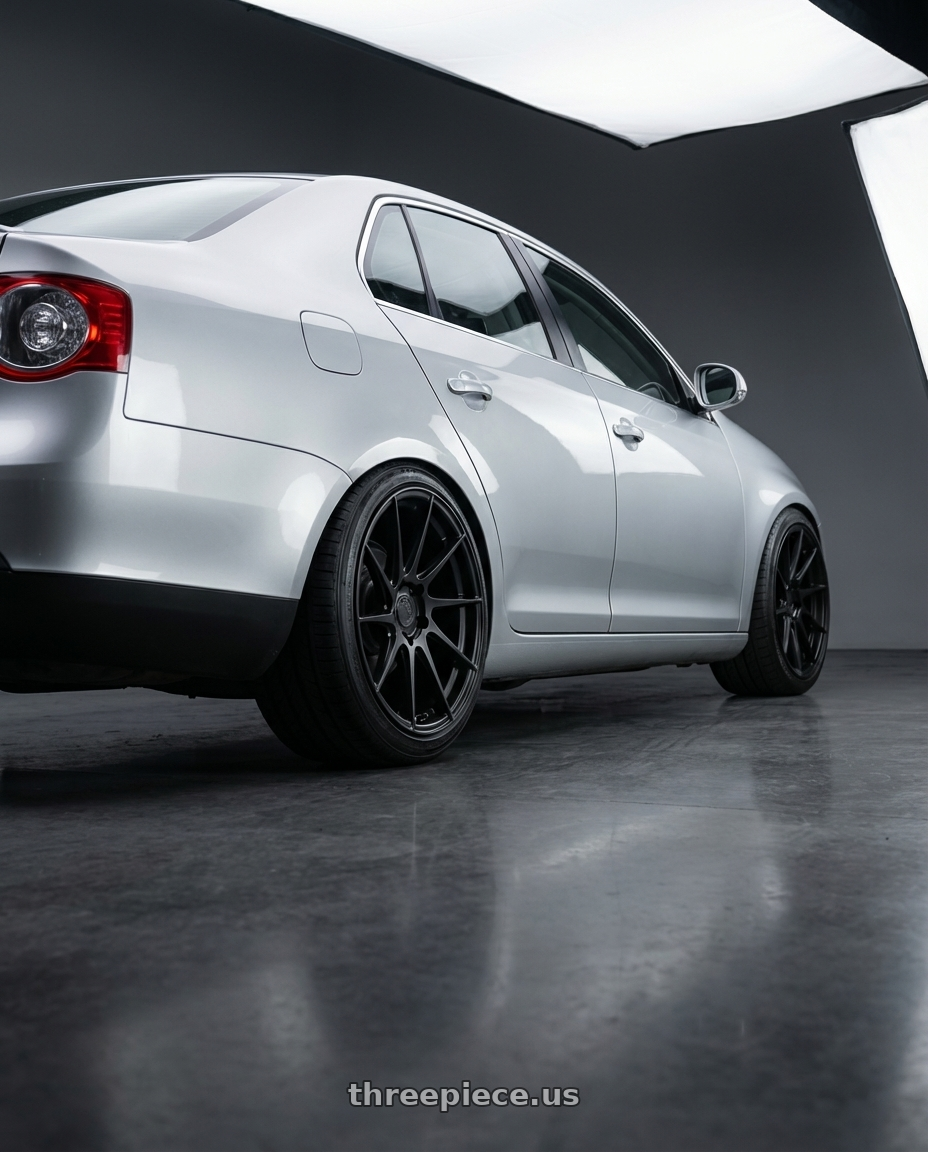 2009 Volkswagen Jetta GLI MK5 with Aodhan AH09 5x112 18x9.5 +35 Matte Black wheels rear three quarter view square tires