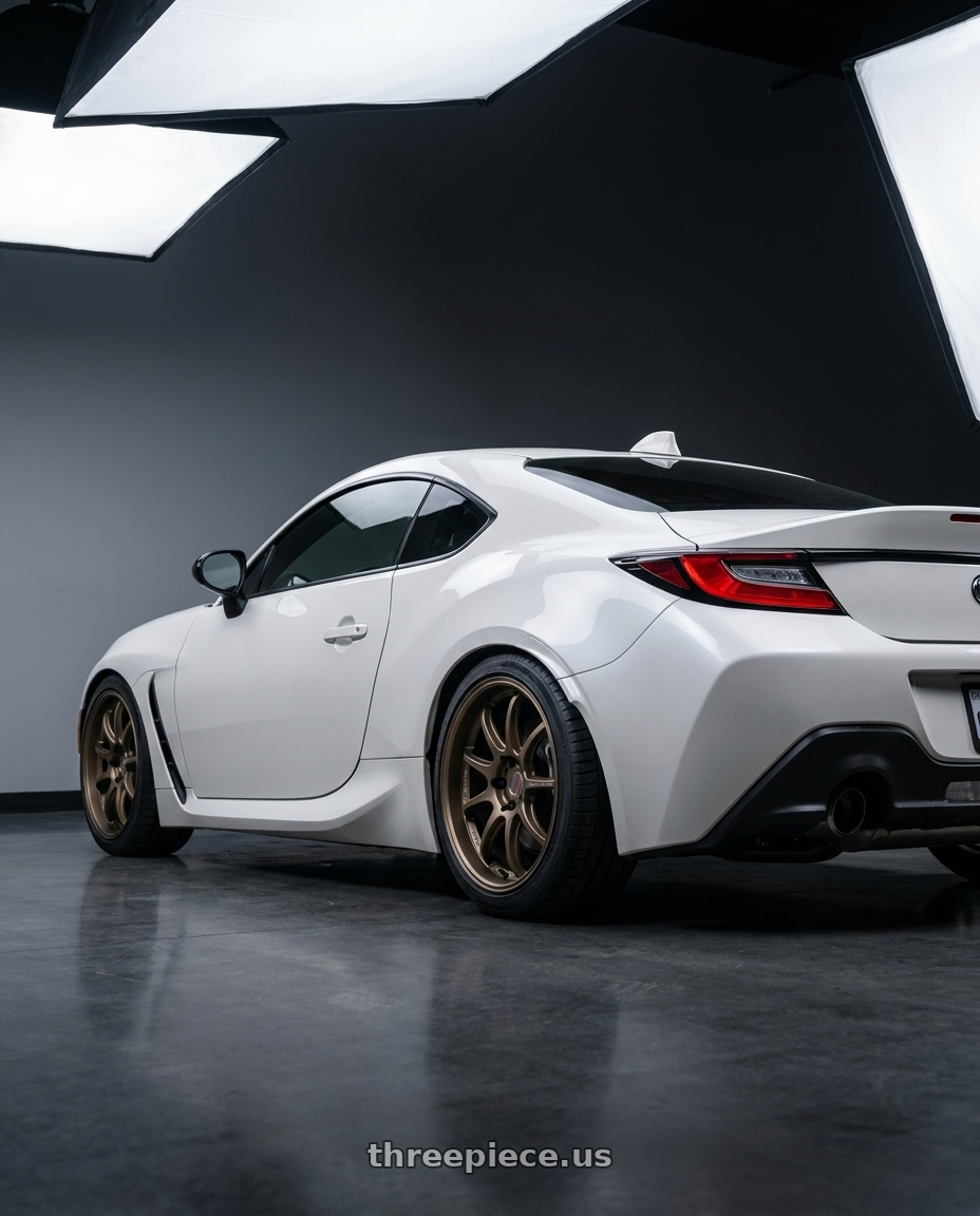 2026 Toyota gr86 with Work Emotion D9r 5x100 18x8.5 +38 Matte Bronze wheels rear three quarter view square tires