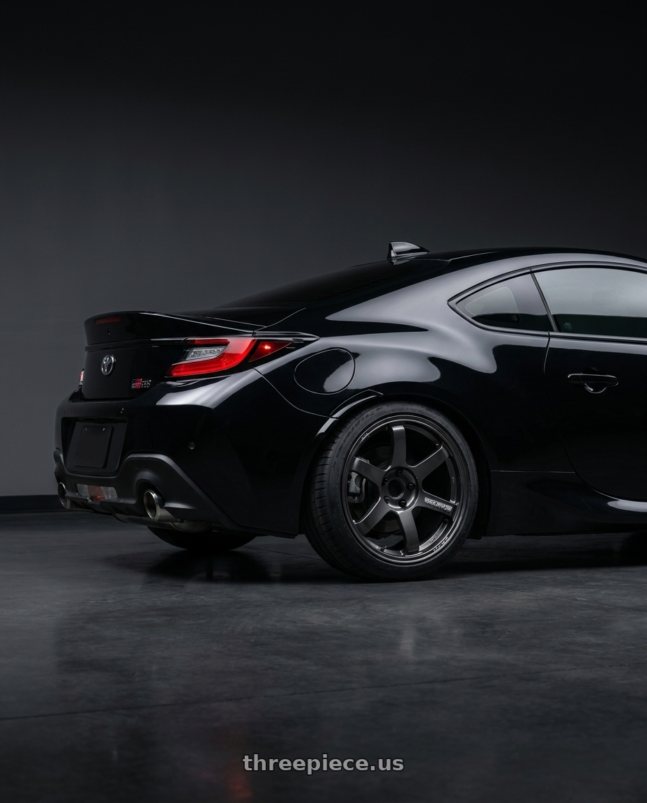 2025 Toyota gr86 with Volk Racing TE37 Saga S-Plus 5x100 18x8.5+45 Diamond Dark Gunmetal wheels rear three quarter view slight stretch tires