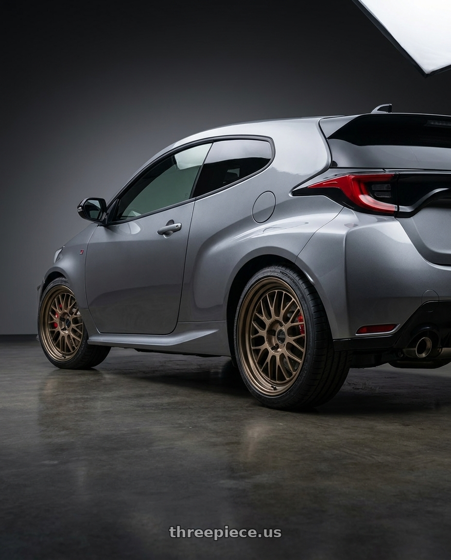 2025 Toyota GR yaris  with Volk Racing 21A 5x114.3 18X8.5+34  Bronze wheels rear three quarter view square tires