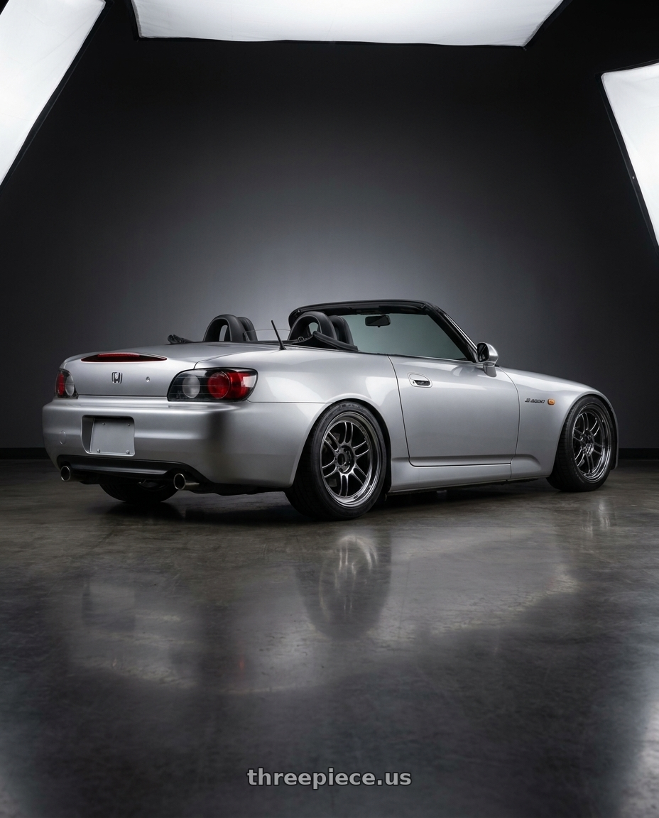 2001 Honda S2000 Sebring Silver Metallic paint, black interior with the top down with Enkei RPF1 5x114.3 17x8.5+30 SBC wheels rear three quarter view square tires