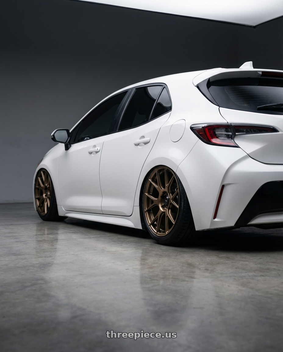2023 Toyota Corolla Hatchback with Konig Ampliform 5x114.3 18x8.5+35 Gloss Bronze wheels rear three quarter view slight stretch tires