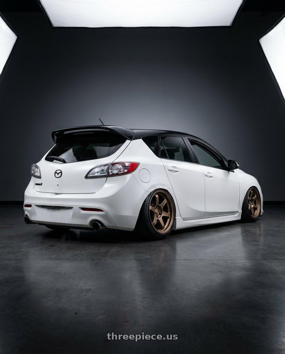 2012 Mazda Mazdaspeed3 with Kansei K12B KNP 5x114.3 18x9 12 Bronze wheels rear three quarter view slight stretch tires