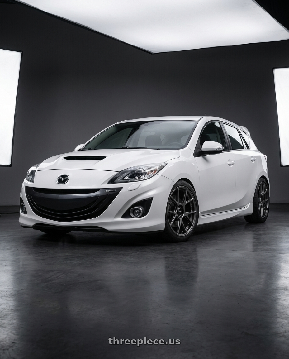 2012 Mazda Mazdaspeed3 with Konig Ampliform 5x114.3 18x9.5+35 Dark Metallic Graphite wheels front three quarter view lowered stance