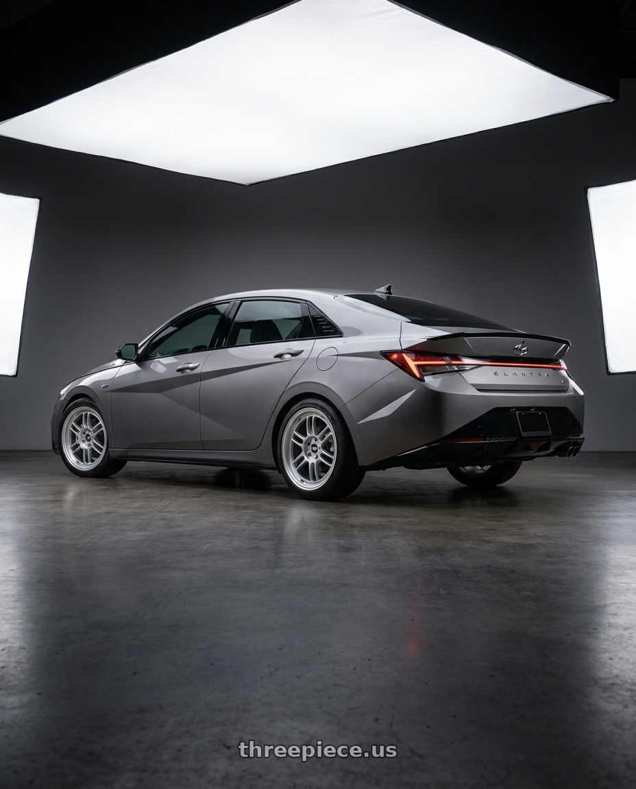 2023 Hyundai Elantra n line with Enkei RPF1 5x114.3 17x8+45 Silver wheels rear three quarter view square tires