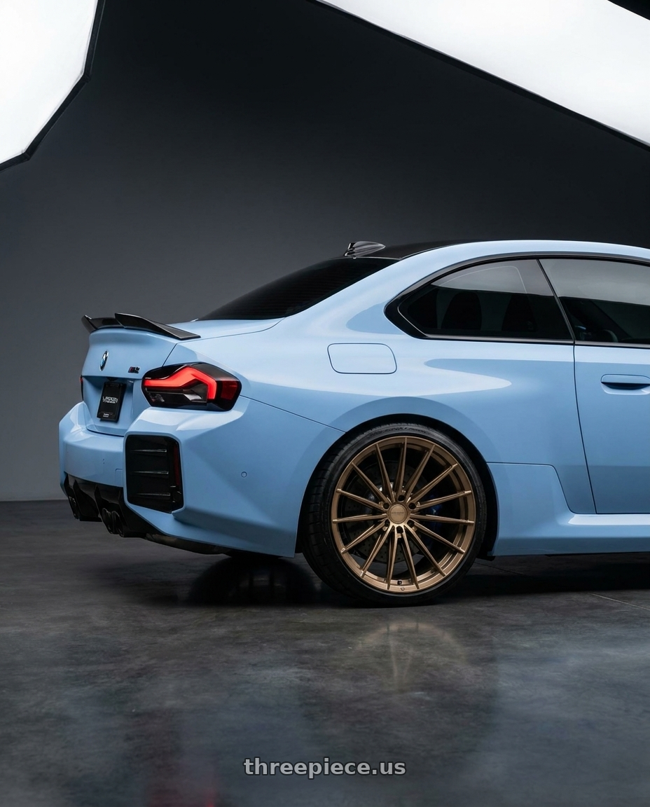 2026 BMW M2 with VOSSEN HFX-4 6X139.7 22x9.5 +20 SATIN BRONZE wheels rear three quarter view square tires