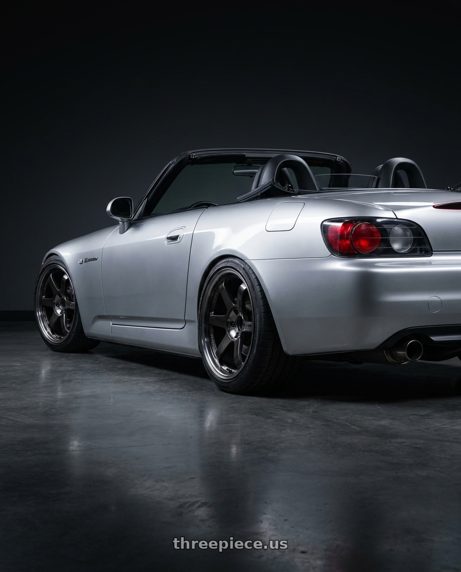 2001 Honda s2000 in Sebring silver metallic with black interior, roof down with Volk Racing TE37SL 5x114.3 18x11 +18 PRESSED DOUBLE BLACK wheels rear three quarter view square tires