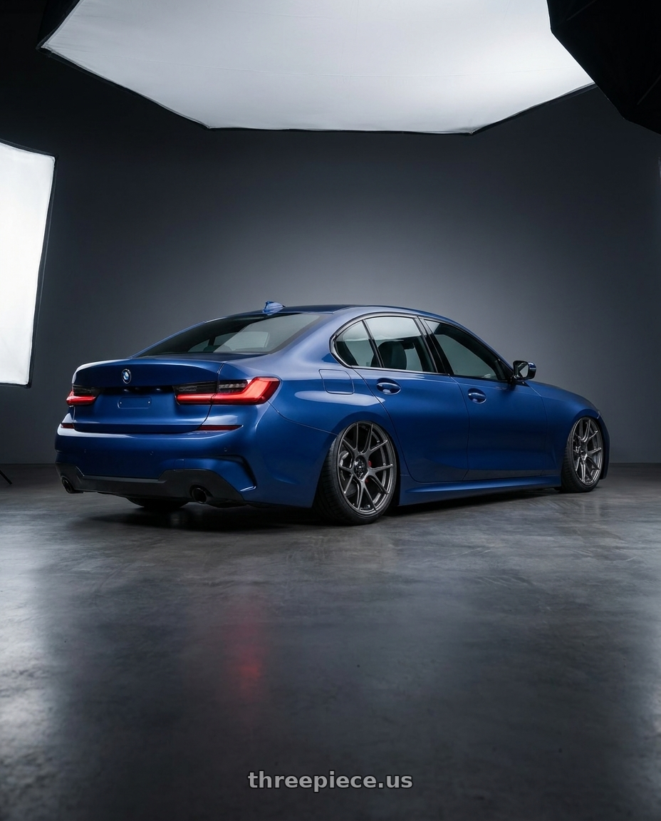 2026 BMW 3-series,deep blue with Konig Ampliform 5x120 19x10+28 Dark Metallic Graphite wheels rear three quarter view slight stretch tires