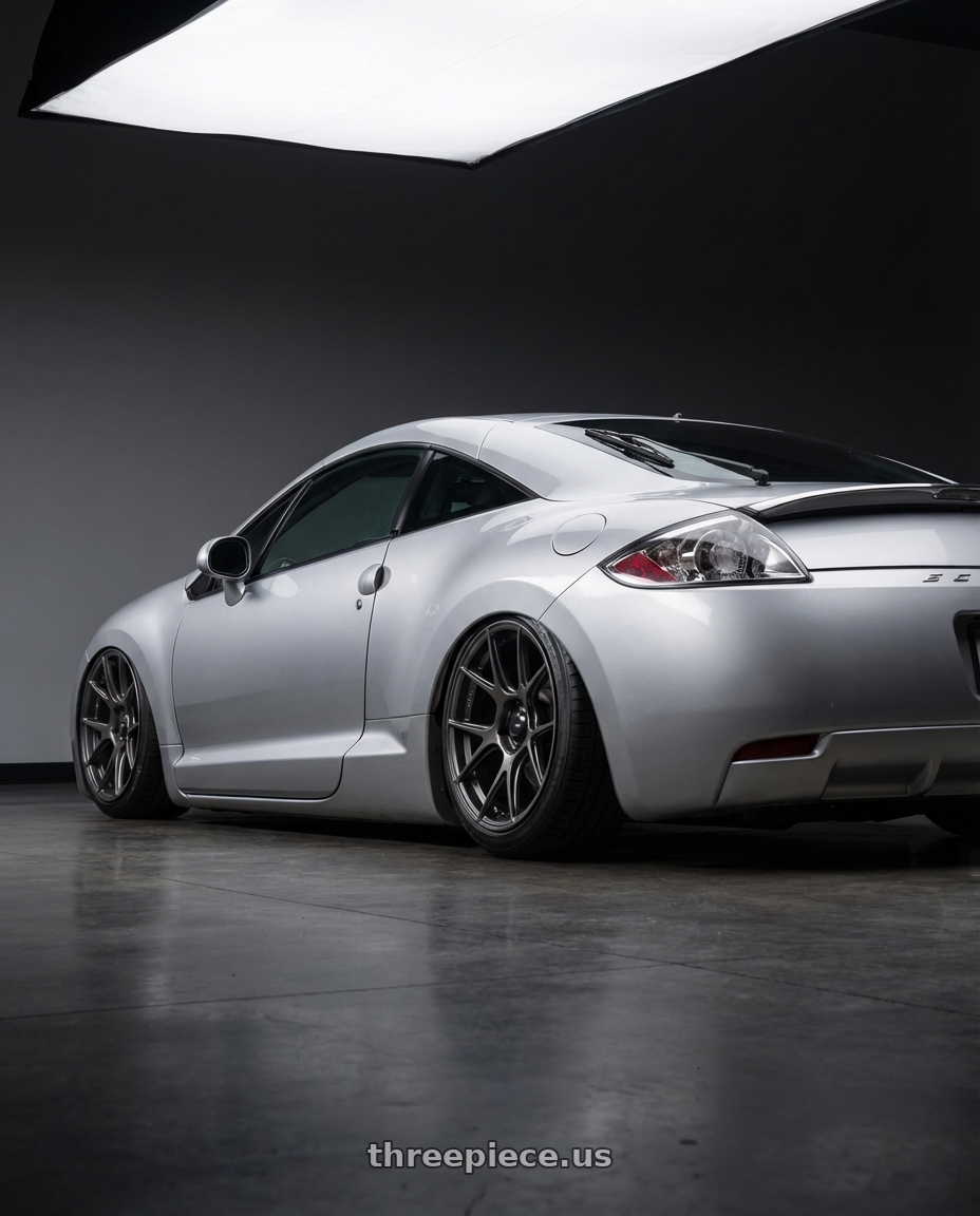 2010 Mitsubishi Eclipse with Konig Ampliform 5x114.3 19x9.5+35 Dark Metallic Graphite wheels rear three quarter view slight stretch tires