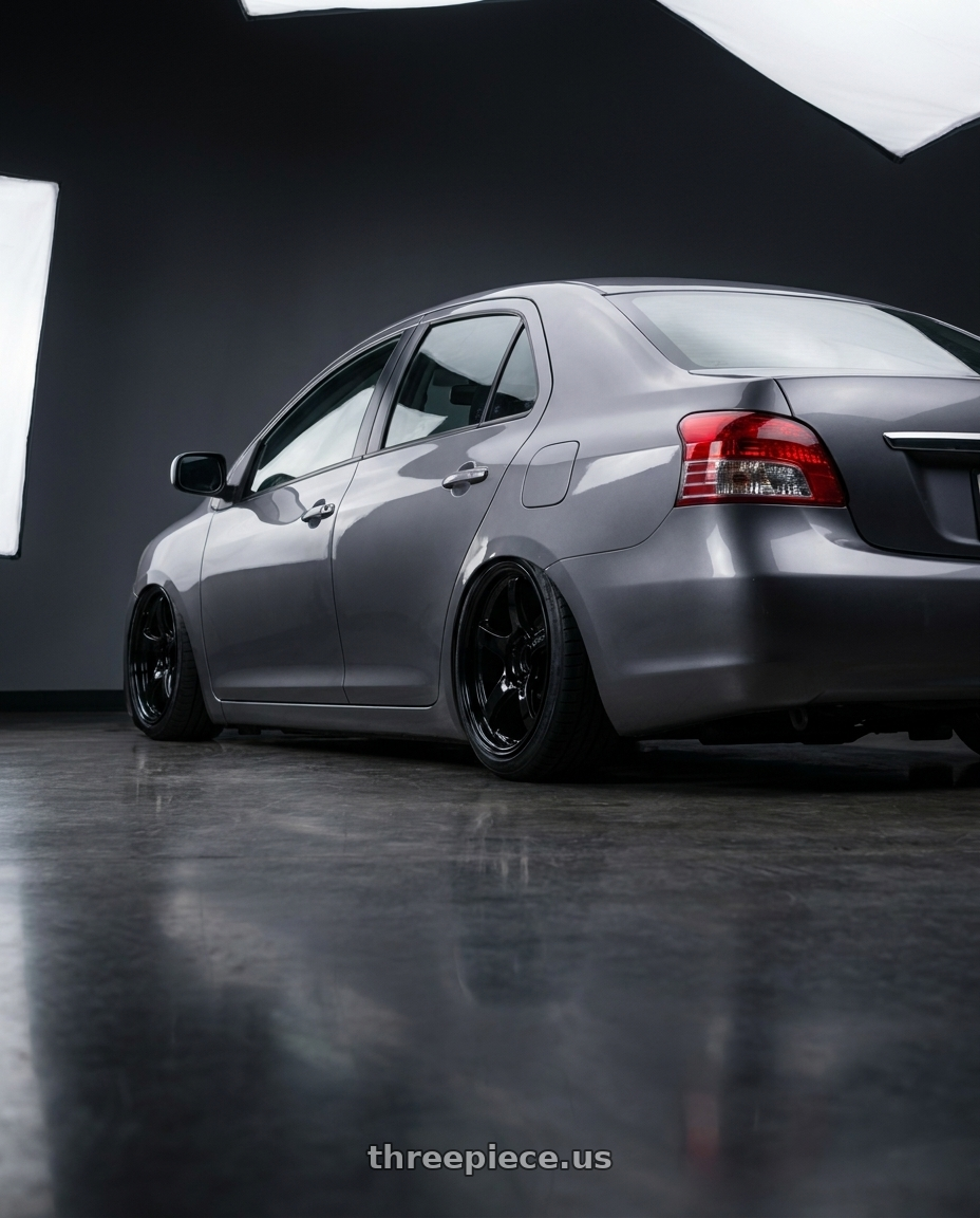 2012 Toyota vios with Gram Lights 57CR 4x100 15x8+35 Glossy Black wheels rear three quarter view slight stretch tires