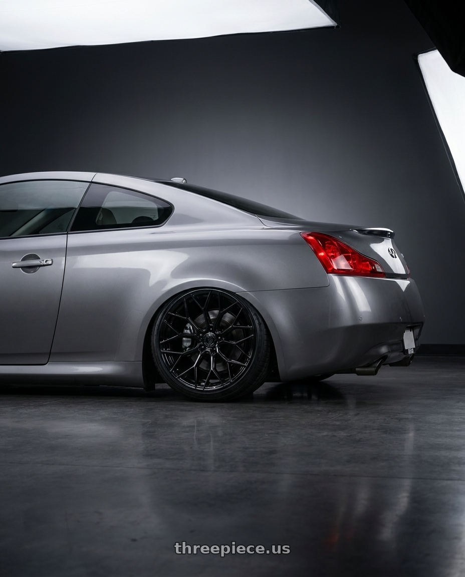 2007 Infiniti g37 with DOLCE PERFORMANCE PISTA 5x114.3 19x9.5 +40 Gloss Black wheels rear three quarter view slight stretch tires
